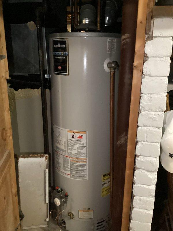 Responded to no hot water call for Bradford White natural gas water heater with Defender Safety System. Unit failed to maintain burner operation following gas service interruption caused by utility company gas line damage in area. Utility personnel previously attempted unsuccessful relight. Upon inspection, confirmed burner would not stay lit, indicating likely damage to gas valve or thermocouple assembly from initial incident. Documented existing installation including copper supply lines, shut-off valves, and adjacent water treatment equipment. Captured detailed photographs of unit model/serial information, plumbing connections, and overall installation for utility company claim documentation. Replaced water heater to restore hot water service to residence.