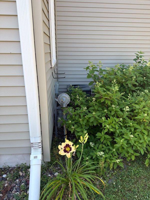 Responded to no cooling complaint on 5-year-old Goodman air conditioning system. Upon arrival, found thermostat calling for cooling with indoor blower operating normally, but outdoor unit condenser fan running while compressor failed to start. Diagnosed failed dual run capacitor with hermetic terminal reading 0 microfarads instead of rated 40/5 specification. Replaced defective capacitor with proper replacement part, restored system to full operation, and verified 15-20 degree temperature split across evaporator coil, confirming proper cooling performance.