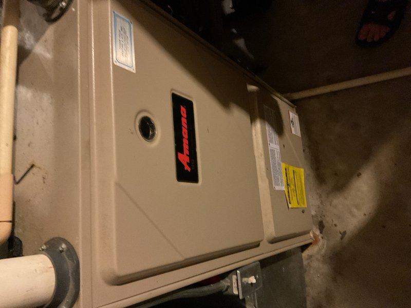 Responded to a no-cooling complaint on a 2003 Amana air conditioning system for a second opinion after previous contractor diagnosed a failed compressor. Upon arrival, discovered the outdoor condensing unit had no run capacitor installed. Verified equipment specifications and installed the correct 35/5 µF dual run capacitor, then restored all electrical connections and energized the system for testing. Outdoor condenser fan motor started but operated at abnormally low speed, and the compressor failed to start. Performed electrical diagnostics including measuring compressor winding resistance between common-to-run, common-to-start, and run-to-start terminals. Also tested each terminal to ground and copper line set to check for grounded windings; all readings indicated no short to ground. Given the unit's age of over 20 years, the abnormal fan motor operation, and compressor failure to start even after capacitor replacement, discussed overall system condition and available options with h