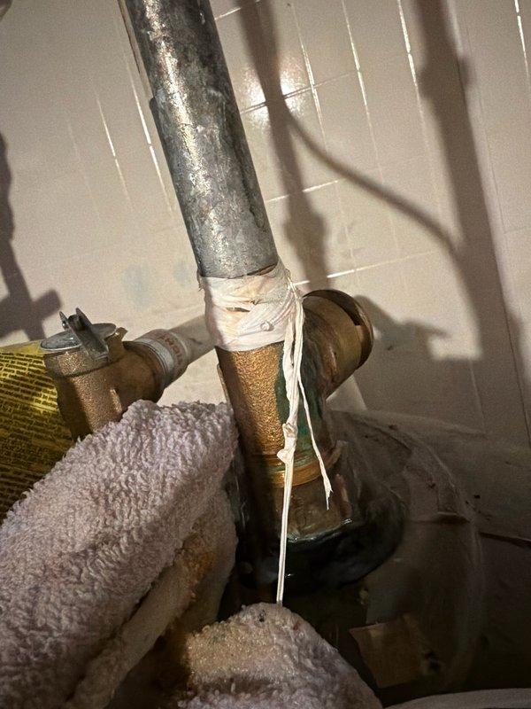 Responded to water leak emergency at Marathon water heater. Upon inspection, identified leak originating from vacuum relief tee at top of unit, not bottom as initially reported. Temporarily secured affected piping connections and documented extensive frost buildup on surrounding plumbing components indicating potential insulation issues. Ordered replacement vacuum relief tee for Marathon unit and scheduled return visit to complete installation and restore system to proper working condition.
