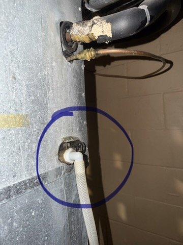 Responded to call for constant dripping from air conditioner condensation pipe in basement causing water accumulation on concrete floor. Cleaned and flushed evaporator coil drain pan to remove debris and buildup causing drainage obstruction. Verified proper condensate drainage and system operation on 1988 air conditioning unit.