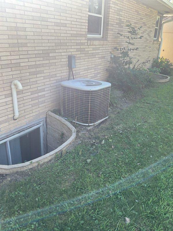 Responded to call for constant dripping from air conditioner condensation pipe in basement causing water accumulation on concrete floor. Cleaned and flushed evaporator coil drain pan to remove debris and buildup causing drainage obstruction. Verified proper condensate drainage and system operation on 1988 air conditioning unit.