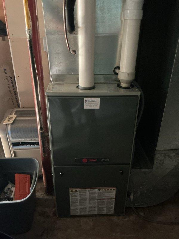 Responded to callback for loud noise from Trane air conditioning system following recent tune-up. Upon arrival, unit was operating quietly with no audible abnormalities present. Performed comprehensive inspection of indoor air handler and outdoor condenser unit, measuring amperage draw and low-voltage readings throughout the system. All electrical measurements were within normal operating parameters except for compressor capacitor readings, which showed out-of-specification values. Diagnosed faulty capacitor as the probable cause of intermittent noise complaint. Replaced defective capacitor with new unit, restoring proper electrical values and eliminating potential noise source. System tested and verified operational.