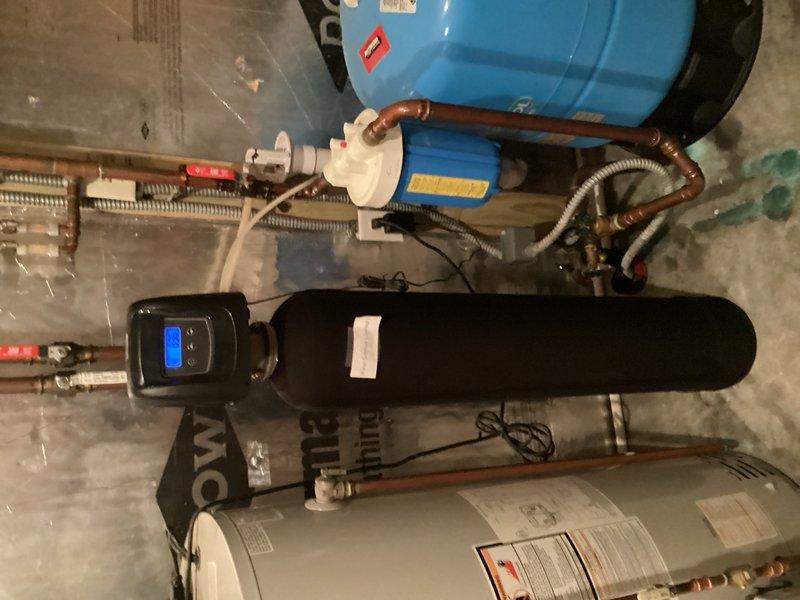 Responded to service call for water quality assessment following plumber's recommendation to test iron levels. Upon arrival, performed iron test on water supply and conducted thorough inspection of existing water treatment equipment. Discovered property already equipped with functional reverse osmosis system serving upstairs refrigerator and downstairs bar area. Explained RO system capabilities and confirmed it adequately addresses drinking water quality concerns. Discussed additional under-cabinet RO installation options for enhanced convenience if desired. Documented existing HVAC and water treatment system configuration including Bryant furnace, water heater, and blue pressure tank with associated copper piping and connections.