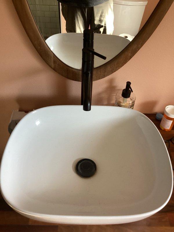 Completed comprehensive plumbing inspection of residential bathroom fixtures as part of recurring maintenance program. Performed thorough examination of toilet, including tank components, fill valve, flapper assembly, and flush mechanism to ensure proper operation and identify potential water waste issues. Inspected vessel sink installation, verifying proper mounting, drain assembly function, and absence of leaks at connection points. Evaluated faucet operation and checked for drips or irregular water flow. Documented current condition of all plumbing fixtures with photographic evidence for maintenance records.