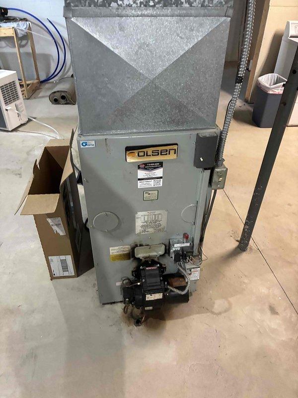 Responded to no cooling complaint on 10+ year old R22 system where customer reported loud buzzing noise before condenser failure. Diagnosed and replaced failed capacitor, restoring condenser operation. Verified refrigerant charge levels were within acceptable range. Installed customer-supplied air filter, cleared condensate drain line, and confirmed condenser coil cleanliness. Advised customer of system age and R22 refrigerant phase-out, recommending against major future repairs due to equipment obsolescence and oil furnace configuration. Unit tested and left operating normally.
