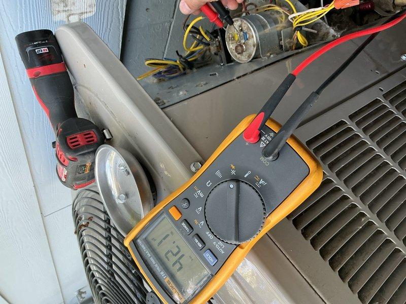 Completed preventive maintenance on residential AC system including air filter replacement, condensate drain line flush, and verification of blower speeds and air temperatures. During inspection, discovered outdoor unit capacitor reading 42/5 MFD against rated 45/5 MFD specification, indicating weakened performance. Replaced defective capacitor under warranty coverage. Inspected and verified proper operation of contactor and electrical wiring connections. Cleaned outdoor condenser unit and confirmed refrigerant charge within manufacturer specifications. All system components operating within normal parameters upon completion.