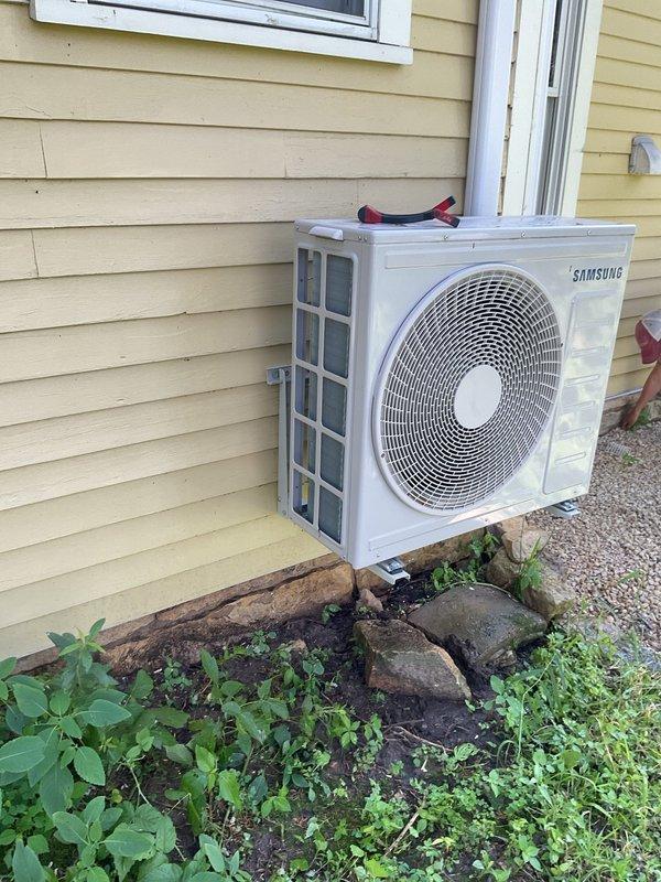 Performed preventive maintenance tune-up on dual-head Samsung mini-split system, approximately two years old. Cleaned and inspected both indoor air handlers, removing debris including insect contamination from internal components. Cleaned evaporator coils, washed filters, and verified proper airflow. Inspected outdoor condenser unit, cleaned coil fins, and confirmed proper operation. Measured and verified temperature differential across both zones within acceptable range. Flushed condensate drain lines to ensure proper drainage and address reported condensation concerns. All system components tested and confirmed operating within normal parameters upon completion.