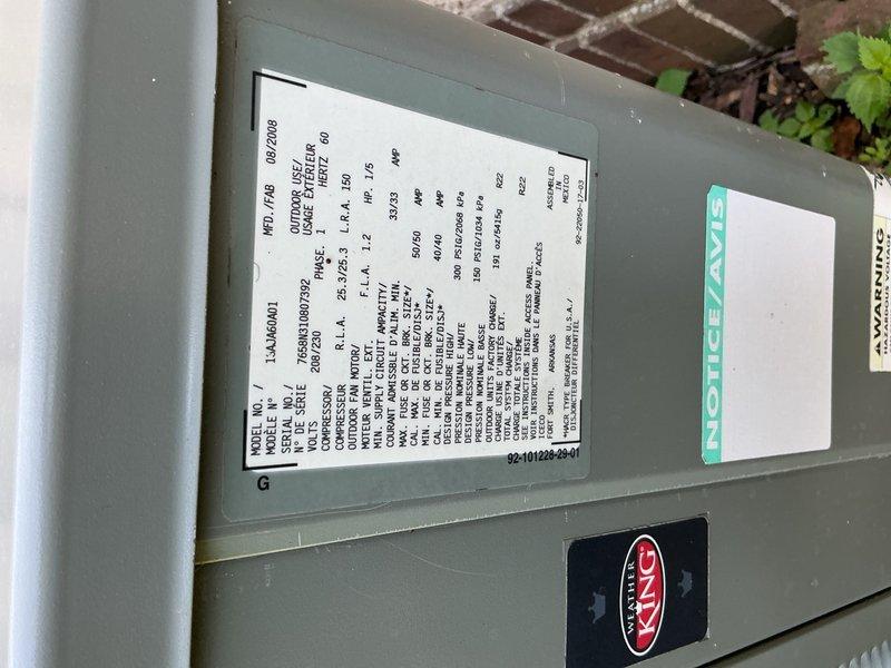 Responded to no cooling complaint on R-22 refrigerant system installed in 2008. Diagnosed system as low on refrigerant with suction line frost buildup, low side pressure at 51 PSI with 3.9°F superheat and 27.2°F vapor saturation temperature, and high side pressure at 221 PSI with subcooling at 221°F and liquid saturation at 108°F. Found outdoor condenser coils heavily clogged with cottonwood debris restricting airflow. Advised homeowner to clean coils and scheduled estimate appointment for system replacement due to age and R-22 refrigerant phase-out considerations.