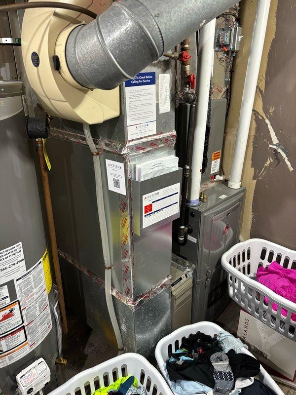 Responded to investigate tapping noise occurring when hot water was activated in upstairs bathroom. Inspected utility room where PEX water lines were accessible through exposed wall opening. Identified unsecured PEX hot water lines as the source of the tapping sound. Repositioned and secured the loose PEX piping within the wall cavity. Verified tapping noise ceased after adjustment. Recommended insulating the hot water line if noise recurs in the future to prevent thermal expansion sounds.