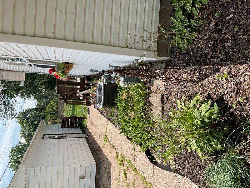 Responded to complaint of air conditioning system running continuously without adequate cooling. Inspected 2017 Carrier air conditioning unit matched with 2003 Nordyne furnace. Used FLIR thermal imaging to verify cooling performance, measuring 56°F air temperature leaving evaporator with 80°F indoor ambient temperature, confirming normal temperature split and proper refrigerant charge. Inspected outdoor condenser unit and performed light coil rinse; coil showed minimal dirt accumulation. Discovered heavily restricted air filter with visible deflection, indicating significant airflow reduction. Replaced air filter and demonstrated restriction to homeowner. Discussed thermostat usage patterns, which revealed system being turned off during portions of the day, resulting in extended recovery run times when reactivated. System operating within normal parameters with no mechanical deficiencies identified. Extended runtime attributed to combination of restricted airflow from dirty filter and 