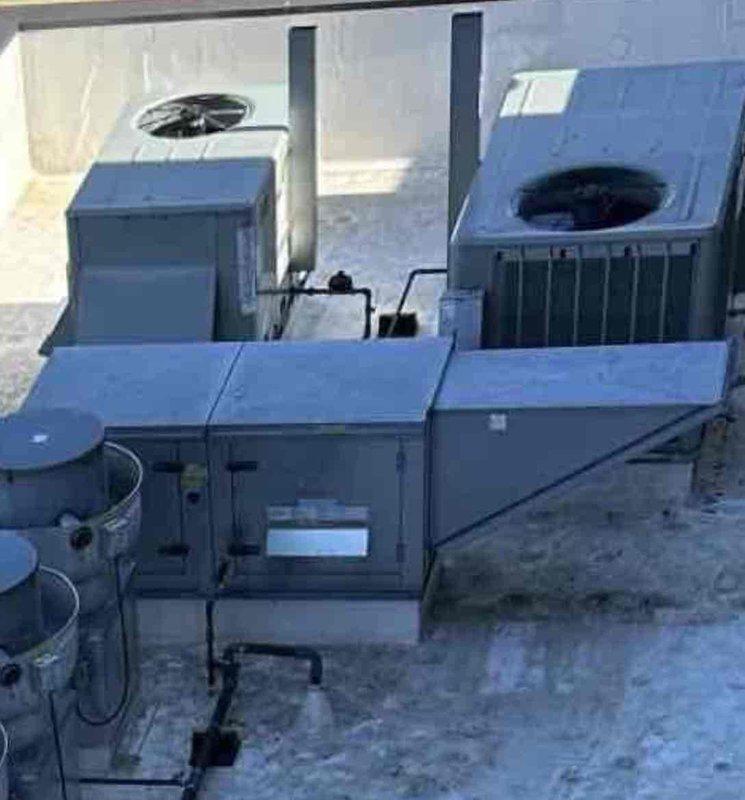 Responded to no cooling complaint on commercial rooftop unit serving kitchen area with interior temperatures reaching 80-90 degrees. Diagnosed failed smoke detector preventing system operation, bypassed detector to restore cooling functionality. Accessed electrical control panel, inspected relay board and wiring connections, and successfully restored unit to normal operation.