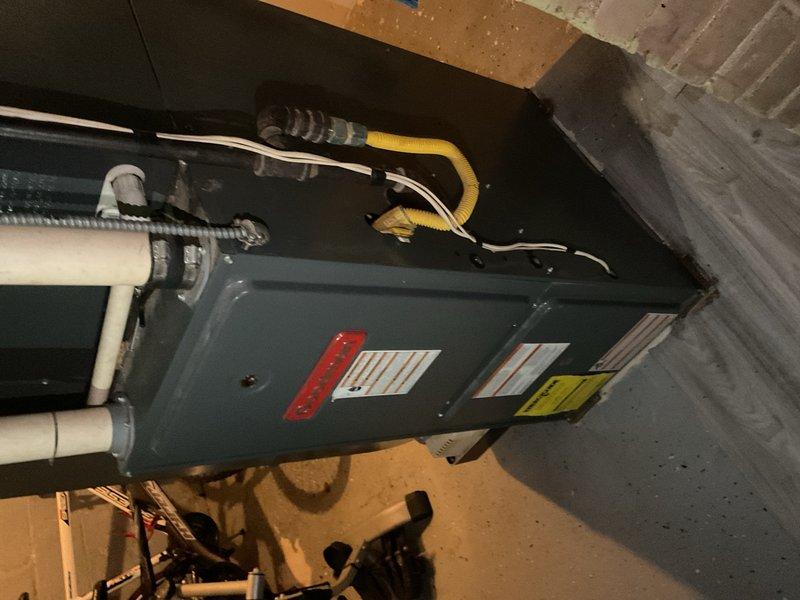 Responded to no cooling complaint on 2007 Goodman AC system. Upon arrival, found indoor temperature at 94°F with outdoor ambient at 107°F in direct sun. Diagnosed dual run capacitor with failed fan side terminal causing compressor to operate while condenser fan remained inoperative. Replaced defective dual run capacitor and tested system operation. Verified proper compressor and condenser fan motor function, confirmed adequate refrigerant charge levels, and left unit operating normally. Advised occupant that extended runtime would be required to bring indoor temperature down to setpoint due to extreme heat load differential.