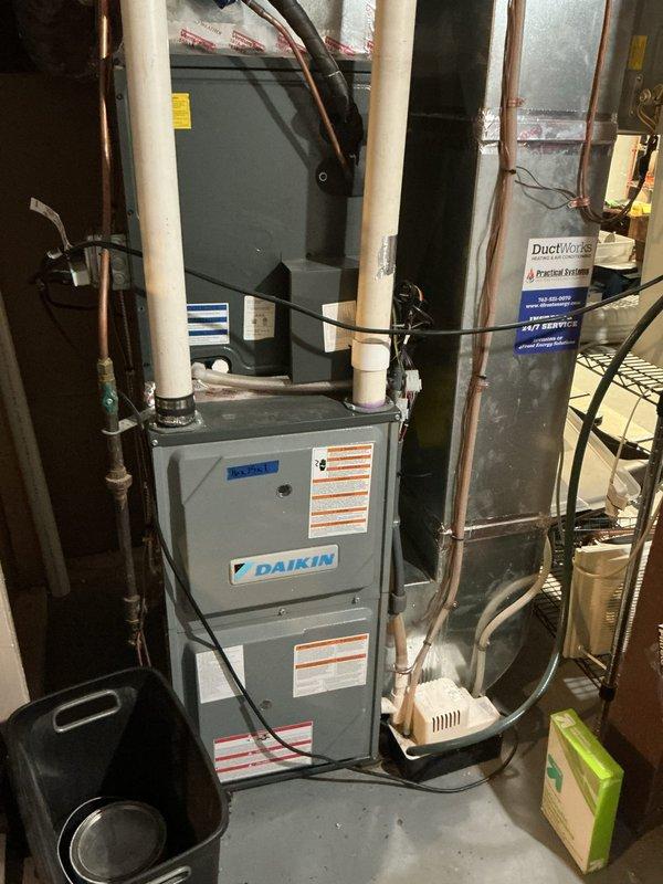Completed annual cooling tune-up on single heat pump system. Performed comprehensive inspection of outdoor condenser unit and indoor Daikin air handler with all components operating within normal parameters. Exterior unit shows significant weathering and surface corrosion on cabinet panels but remains functionally sound with no performance issues identified. Verified refrigerant lines, electrical connections, condensate drainage, and PVC venting all secure and properly configured. System tested and confirmed running efficiently with no service concerns noted at this time.
