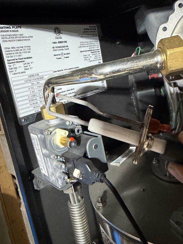 Responded to no hot water condition on combi boiler system experiencing recurring ignition failure. Unit displayed "ignition trials exceeded" error code, consistent with previous service history spanning two years. Performed system reset, cleared error codes, and cleaned flame sensor and ignition assembly to restore temporary operation. 

Upon inspection, identified Lennox furnace integrated into system piping configuration between gas regulator and boiler unit. Customer reported increased failure frequency during winter months when forced air heating is in use, suggesting potential gas pressure deficiency under higher demand conditions. Visual documentation captured internal components including gas valve assembly, burner components, and system rating plate specifications.

Recommended follow-up service with HVAC technician equipped with precision manometer to conduct comprehensive gas pressure testing at inlet and manifold, as inadequate gas supply appears to be underlying cause of c