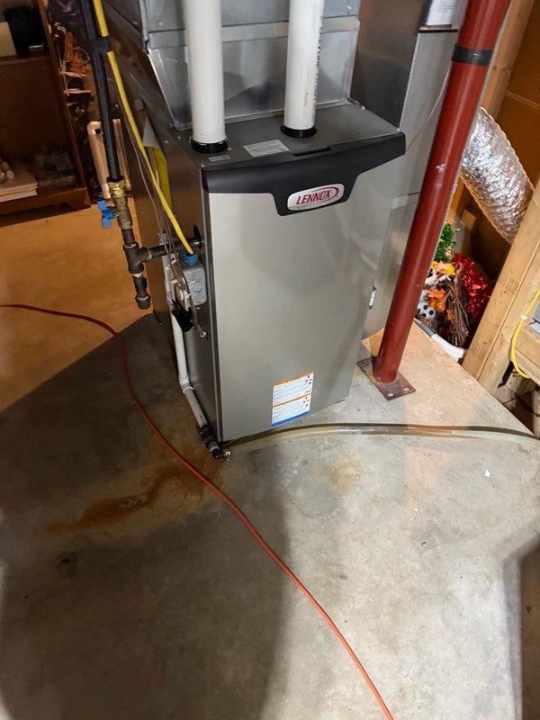 Responded to no hot water condition on combi boiler system experiencing recurring ignition failure. Unit displayed "ignition trials exceeded" error code, consistent with previous service history spanning two years. Performed system reset, cleared error codes, and cleaned flame sensor and ignition assembly to restore temporary operation. 

Upon inspection, identified Lennox furnace integrated into system piping configuration between gas regulator and boiler unit. Customer reported increased failure frequency during winter months when forced air heating is in use, suggesting potential gas pressure deficiency under higher demand conditions. Visual documentation captured internal components including gas valve assembly, burner components, and system rating plate specifications.

Recommended follow-up service with HVAC technician equipped with precision manometer to conduct comprehensive gas pressure testing at inlet and manifold, as inadequate gas supply appears to be underlying cause of c