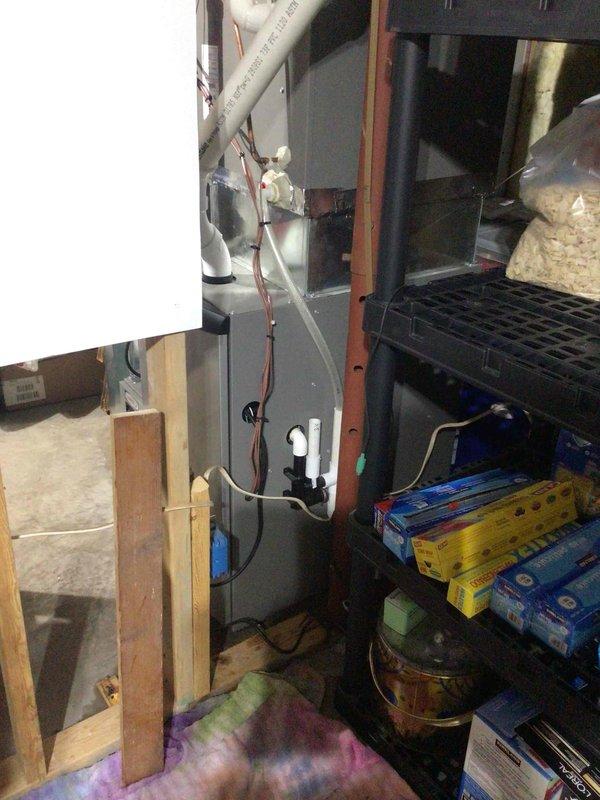 Responded to report of significant water leak originating from furnace area. Upon inspection, identified clogged condensate drain line from air conditioning system as source of water accumulation. Removed AC drain hose from condensate trap and cleared blockage by blowing compressed air through the line, successfully restoring proper drainage and resolving the leak issue.