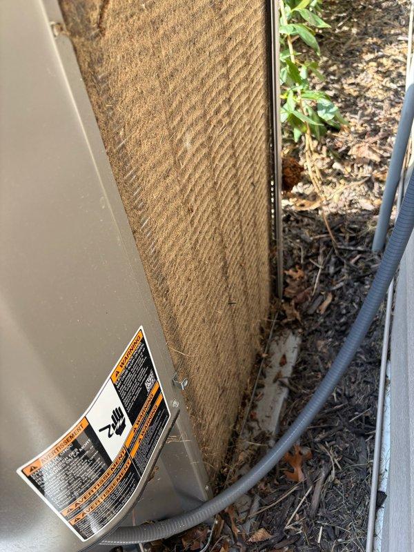 Completed comprehensive AC maintenance on residential split system. Cleaned heavily obstructed condenser coils that were plugged with grass clippings and lawn debris. Inspected and verified proper operation of contactor and capacitor. Advised homeowner to set filter change reminders on thermostat and requested lawn maintenance personnel redirect mower discharge away from outdoor unit to prevent future coil blockage. System operating within normal parameters with no deficiencies identified.