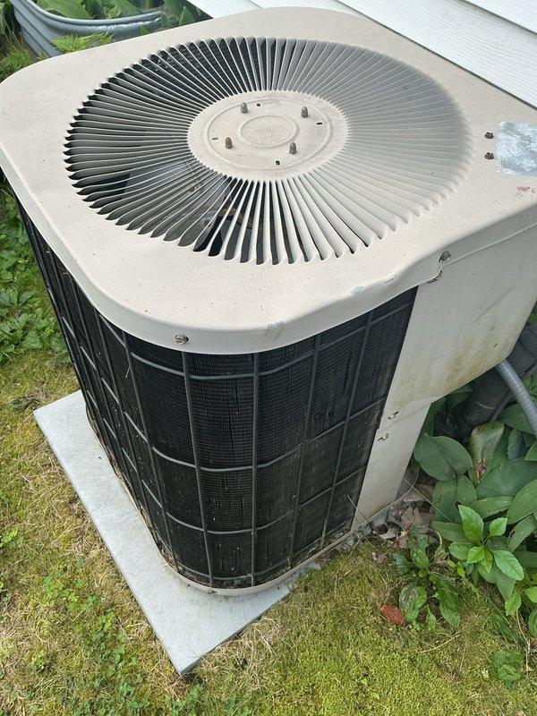 Responded to no cooling call on 28-year-old R22 system with condenser producing faint hum but not starting. Diagnosed failed dual capacitor on fan side using digital multimeter, confirmed component failure preventing condenser fan motor operation. Replaced dual capacitor and restored system to operational status; recommended comfort advisor consultation due to system age and R22 refrigerant phase-out considerations.