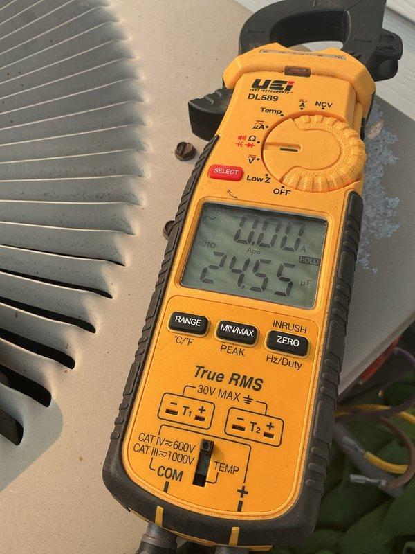 Responded to no cooling call on 28-year-old R22 system with condenser producing faint hum but not starting. Diagnosed failed dual capacitor on fan side using digital multimeter, confirmed component failure preventing condenser fan motor operation. Replaced dual capacitor and restored system to operational status; recommended comfort advisor consultation due to system age and R22 refrigerant phase-out considerations.