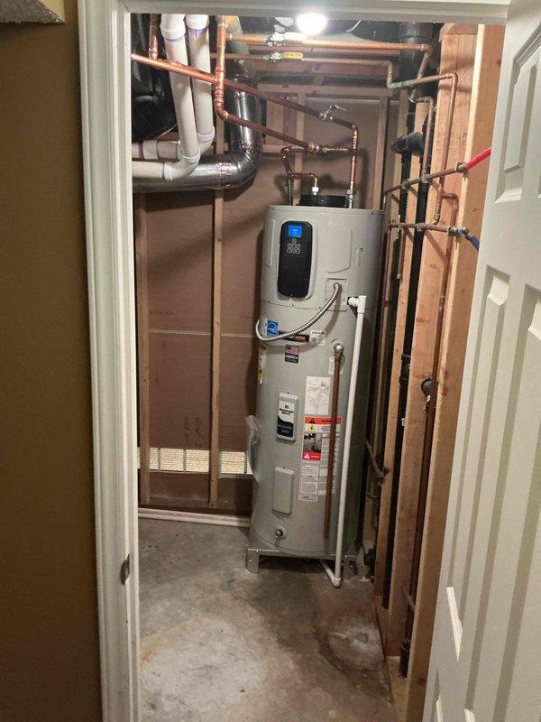 Responded to callback for recurring loud clicking fan noise on Bradford White G2 50-gallon electric hybrid water heater. Unit was producing hot water but fan exhibited same failure symptoms as previous April 2026 repair. Contacted technical support to diagnose repeated fan component failure. Documented unit condition with photographs showing water heater installation, digital display panel, copper supply piping, PVC drainage lines, and overall mechanical room configuration. Ordered replacement fan assembly through manufacturer warranty to resolve ongoing noise issue.