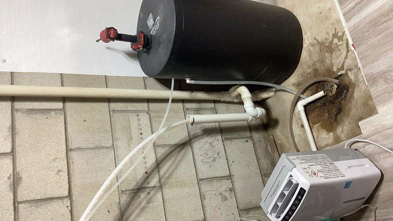 Completed callback service to relocate water heater to its original position following basement waterproofing and drain tile installation. Reconnected all plumbing lines, gas connections, and venting system to the relocated water heater unit. Verified proper operation of all connections and documented final installation with photographs showing completed mechanical room setup with water heater, associated piping, and auxiliary equipment properly positioned and functioning.