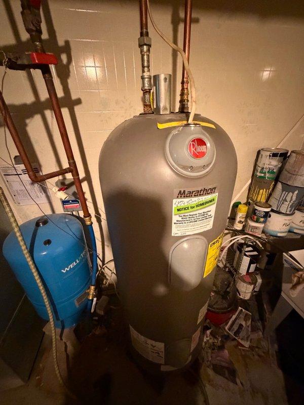 Installed vacuum relief tee on Rheem Marathon water heater to prevent thermal expansion issues and protect the tank from potential vacuum conditions. The brass fitting was integrated into the existing copper piping system at the top of the unit, ensuring proper venting and compliance with plumbing code requirements.