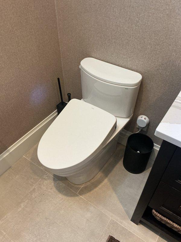 Responded to service call for sewer odors affecting multiple toilets throughout residential property. Conducted comprehensive inspection of six toilet fixtures, including units equipped with bidet seats. Investigated potential sources of sewer gas infiltration, examining wax ring seals, flange connections, and trap integrity. Performed thorough cleaning and testing procedures on all affected fixtures to identify and resolve odor issues. Documented conditions of bathroom facilities with detailed photography showing modern installations with contemporary tile work and fixtures.