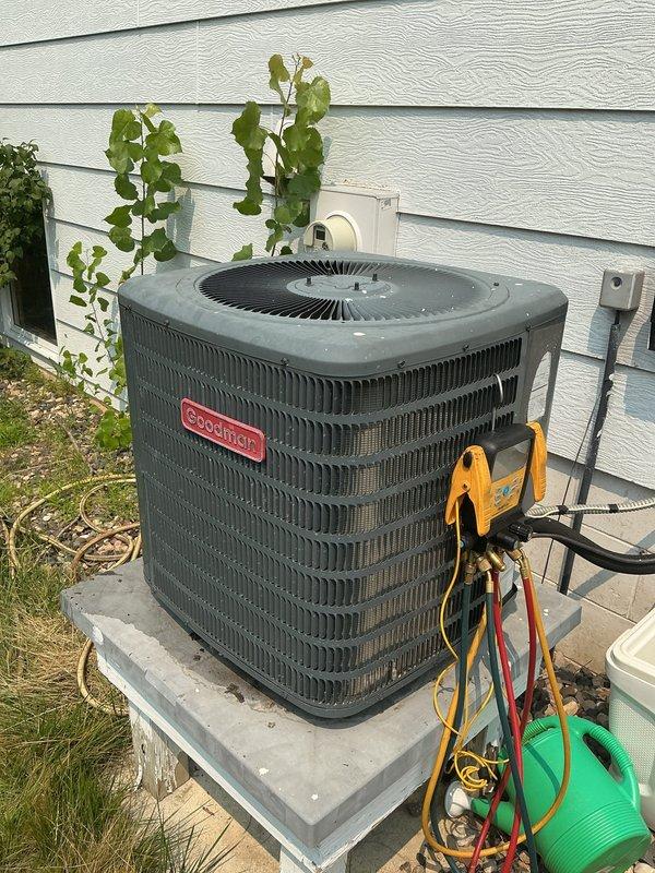 Responded to no cooling complaint on residential HVAC system. Upon arrival, found indoor evaporator coil freezing up and blocking airflow. System was critically low on obsolete refrigerant. During diagnostic testing, refrigerant lines and compressor froze up almost immediately. Reset power to system, but compressor failed to restart, indicating likely compressor failure due to extended operation with insufficient refrigerant charge. 

Inspected furnace and identified original equipment with manufacture date of 1992. Determined aged furnace is probable source of refrigerant leak and system inefficiency. Given the age of equipment (30+ years), obsolete refrigerant type, failed compressor, and compromised system integrity, recommended complete system replacement rather than repair.

Scheduled same-day estimate for new furnace and air conditioning system replacement. Documented existing equipment configuration and conditions with photographs showing indoor furnace/air handler installation 