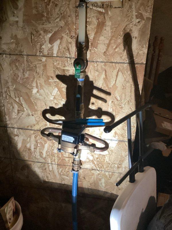 Completed installation of new sump pump system with 1.5-inch discharge piping routed to exterior outlet. Relocated water heater to its original position against the wall following completion of waterproofing work, reconnected all plumbing connections, and verified proper pump operation and drainage flow.