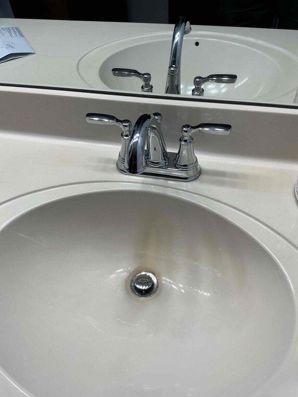Responded to callback regarding loose faucet handles on dual-sink vanity installation from previous week. Removed and retightened chrome faucet handles, confirming that slight movement is inherent to the handle design and within manufacturer specifications. Replaced missing screw in shower floor drain assembly that was inadvertently left out during prior service visit.