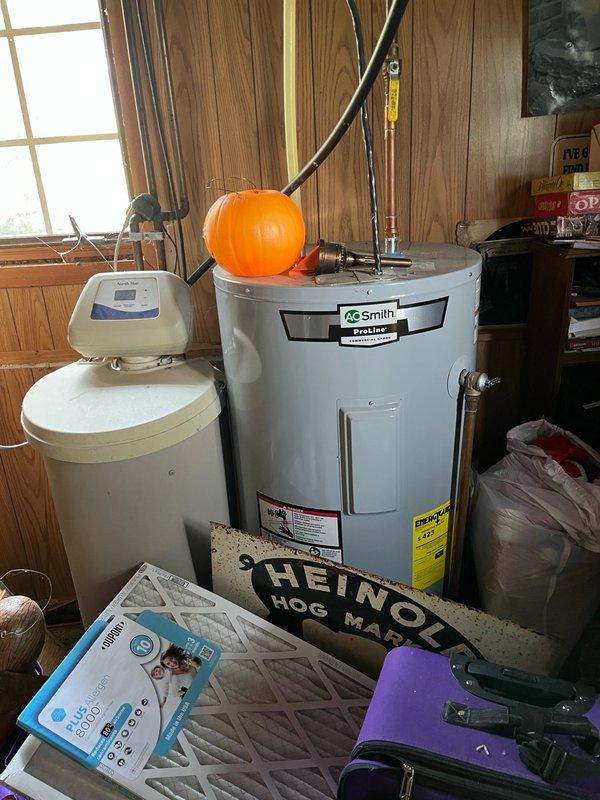 Responded to no cooling complaint on 10+ year old AC system with reported rattling noise from blower assembly. Upon inspection, discovered a picture lodged in the blower wheel causing the noise. Removed foreign object and restored normal blower operation. Identified secondary issue with condensate leaking back through intake, dripping onto gas valve and electrical components in upper furnace cabinet. Installed in-line drain on furnace intake to resolve drainage issue. Replaced existing thermostat with customer-supplied unit. Tested complete system operation including cooling cycle, airflow, and thermostat functionality. All components operating properly with no noise or leakage present at completion.