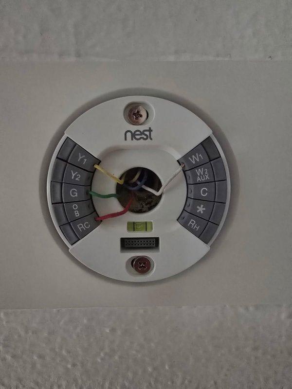 Responded to no cooling complaint with warm air from vents. Inspected recently customer-installed thermostat wiring at wall and verified connections at furnace control board. Confirmed thermostat call signal present. Proceeded to outdoor unit and found condenser operating. Performed comprehensive diagnostic including voltage checks, refrigerant pressures and temperatures, capacitor testing, and low voltage circuit verification. Measured 17-degree temperature split at supply registers, confirming system operating within normal parameters at time of inspection.

Unable to identify definitive cause of intermittent cooling issue reported by occupants. Potential causes include malfunctioning energy saver switch or defective thermostat despite recent replacement. Verified proper thermostat wiring configuration at Nest base plate with appropriate Y, G, RC, and W terminal connections. Instructed homeowner on proper use of HOLD function to prevent schedule overrides affecting set temperature. I