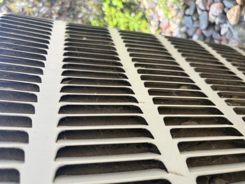 Responded to no cooling complaint on 8-year-old residential air conditioning system experiencing intermittent freezing. Performed diagnostic evaluation and confirmed system low on refrigerant charge, consistent with previous service history from prior year indicating recurring refrigerant loss. Measured supply air temperature at 94.4°F, confirming inadequate cooling capacity. Inspected outdoor condensing unit and noted system charge insufficient to maintain proper operation, resulting in evaporator coil freeze-up under load conditions. Advised homeowner that refrigerant recharge and leak detection service required to restore cooling function and prevent continued freeze-up events. Provided written estimate for refrigerant service via email for customer consideration. Documented findings with photographic evidence of outdoor unit conditions and temperature measurements.
