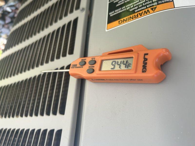 Responded to no cooling complaint on 8-year-old residential air conditioning system experiencing intermittent freezing. Performed diagnostic evaluation and confirmed system low on refrigerant charge, consistent with previous service history from prior year indicating recurring refrigerant loss. Measured supply air temperature at 94.4°F, confirming inadequate cooling capacity. Inspected outdoor condensing unit and noted system charge insufficient to maintain proper operation, resulting in evaporator coil freeze-up under load conditions. Advised homeowner that refrigerant recharge and leak detection service required to restore cooling function and prevent continued freeze-up events. Provided written estimate for refrigerant service via email for customer consideration. Documented findings with photographic evidence of outdoor unit conditions and temperature measurements.