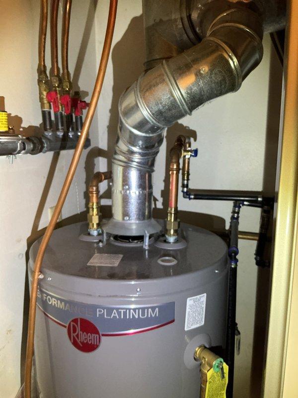 Responded to service call and installed thermostatic mixing valve on residential water heater system. Shut off water supply, cut into hot and cold water lines directly above the water heater unit, and integrated new brass mixing valve with proper copper pipe connections and fittings. Adjusted water heater temperature settings to optimal level, pressure-tested all connections for leaks, and verified proper system operation with correct water temperature delivery at fixtures. All work completed with one-year workmanship warranty.