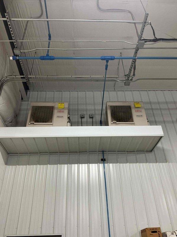 Responded to no cooling complaint with room temperature at 88 degrees. Found outdoor units completely plugged with debris and cleaned condensers by brushing due to inaccessible water source in elevated garage location. After cleaning and startup, discovered one unit icing up and second unit running but not cooling despite compressor and components operating. Unable to verify refrigerant charge due to lack of proper mini split adapter. Recommend follow-up service to check refrigerant levels on both units to diagnose and resolve cooling issues.
