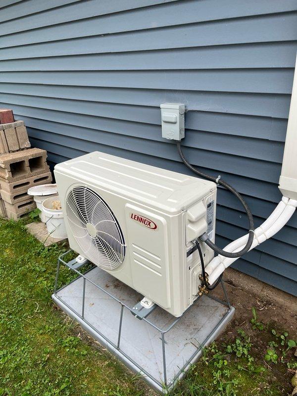 Responded to no cooling complaint on 2-year-old Lennox mini-split system with reported loud hissing sound. Upon arrival, confirmed system was low on R-410A refrigerant for the second time since previous service call last summer when system was recharged and UV dye was added. Performed visual inspection of indoor wall-mounted evaporator unit and outdoor condensing unit, checking accessible refrigerant line connections and components for obvious leak signs. Inspection was hindered by bee activity around outdoor lineset and condensing unit. Weather conditions deteriorated during service call. Unable to complete comprehensive leak detection due to lack of recovery equipment on truck. Discussed warranty coverage with homeowner. System requires follow-up appointment with recovery machine to properly evacuate refrigerant, perform thorough leak search using electronic leak detector and UV light to locate dye traces, and complete necessary repairs before recharging system to manufacturer specif