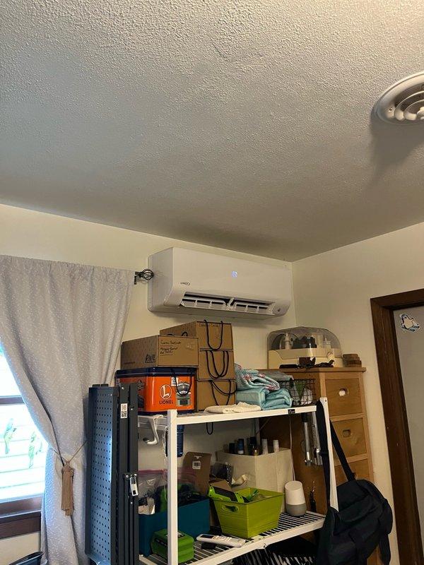 Responded to no cooling complaint on 2-year-old Lennox mini-split system with reported loud hissing sound. Upon arrival, confirmed system was low on R-410A refrigerant for the second time since previous service call last summer when system was recharged and UV dye was added. Performed visual inspection of indoor wall-mounted evaporator unit and outdoor condensing unit, checking accessible refrigerant line connections and components for obvious leak signs. Inspection was hindered by bee activity around outdoor lineset and condensing unit. Weather conditions deteriorated during service call. Unable to complete comprehensive leak detection due to lack of recovery equipment on truck. Discussed warranty coverage with homeowner. System requires follow-up appointment with recovery machine to properly evacuate refrigerant, perform thorough leak search using electronic leak detector and UV light to locate dye traces, and complete necessary repairs before recharging system to manufacturer specif