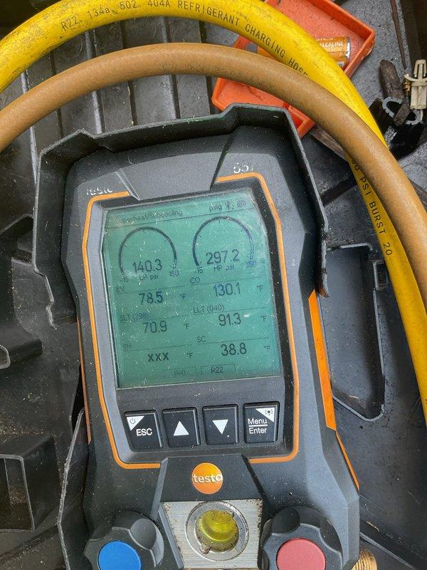 Performed air conditioning tune-up on rental property unit. Found condensing coil completely plugged with debris, causing inadequate cooling performance. Thoroughly cleaned and washed out coil, restoring proper airflow. Verified system operation with refrigerant diagnostics showing 18° superheat and 8° subcooling, with satisfactory temperature drop across evaporator coil. Noted poor installation quality of air handler and furnace by previous contractor. Customer disconnected thermostat to reconnect to smart device after service completion.