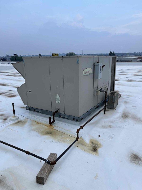 Responded to service call for commercial rooftop unit requiring two compressor replacements. Upon arrival, found unit's main data plate was damaged and missing critical information. Documented existing equipment by photographing accessible nameplate information, individual compressor serial numbers, and model data to enable accurate quoting for replacement compressors. Collected all available unit specifications and compressor identification numbers for procurement purposes.