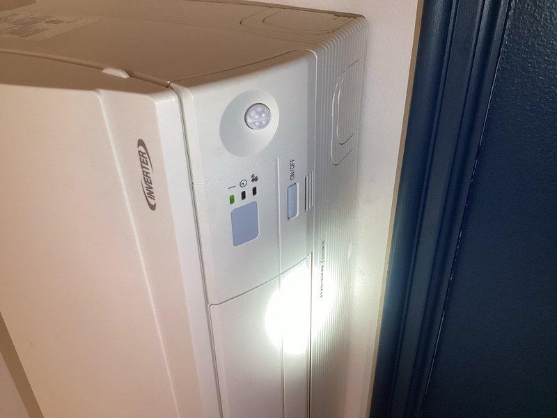 Responded to callback for non-operating dining room mini split system. Upon inspection, discovered failed condensate pump preventing system operation and causing loss of communication power. Verified all wiring connections secure at both indoor and outdoor units. Performed voltage testing per Daikin specifications, measuring 4.5V with signal wire disconnected and 10V when connected, indicating potential circuit board failure at outdoor unit. Previously installed replacement indoor board, which initially activated fan motor for approximately one minute before reverting to same failure mode, suggesting either indoor motor damage affecting new board or compromised outdoor circuit board. All other indoor units confirmed operational. Ordered replacement condensate pump for failed unit. Recommend second technician for return visit due to indoor unit location requiring ladder access at elevated position. System remains inoperable pending parts arrival and installation.