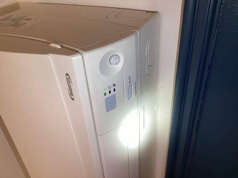 Responded to callback for non-operating dining room mini split system. Upon inspection, discovered failed condensate pump preventing system operation and causing loss of communication power. Verified all wiring connections secure at both indoor and outdoor units. Performed voltage testing per Daikin specifications, measuring 4.5V with signal wire disconnected and 10V when connected, indicating potential circuit board failure at outdoor unit. Previously installed replacement indoor board, which initially activated fan motor for approximately one minute before reverting to same failure mode, suggesting either indoor motor damage affecting new board or compromised outdoor circuit board. All other indoor units confirmed operational. Ordered replacement condensate pump for failed unit. Recommend second technician for return visit due to indoor unit location requiring ladder access at elevated position. System remains inoperable pending parts arrival and installation.