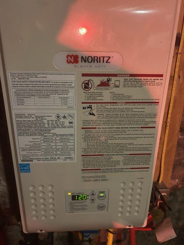 Responded to service call for Noritz NR98-DVC tankless water heater displaying error code 14, indicating flame failure or combustion issues. Upon inspection, determined unit is over 12 years old and has never been flushed, resulting in significant hard water mineral buildup in the heat exchanger restricting flow and causing unit shutdowns. Provided estimate for descaling flush service to remove calcium deposits and restore proper operation. Advised that if flushing does not resolve the issue, heat exchanger replacement or full unit replacement may be necessary due to age and condition of equipment.