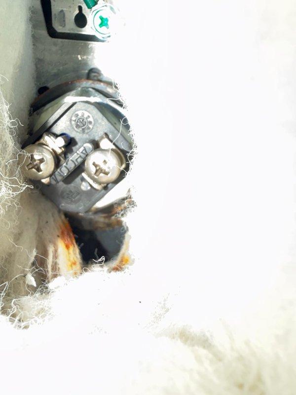 Responded to a callback for water accumulation under the water heater following a recent element and thermostat replacement. Upon inspection, confirmed no leaks at either element port despite visible corrosion around the element openings. Discovered the lower element insulation retained moisture from water intrusion during the previous service, and identified a dripping drain valve. Expelled trapped water from the jacket insulation, cleaned up standing water beneath the unit and around the exterior, and installed a cap on the drain port to stop the drip. Left access covers removed to facilitate air circulation and drying of the insulation over the next several days. Provided a replacement estimate should the moisture issue persist after the drying period.