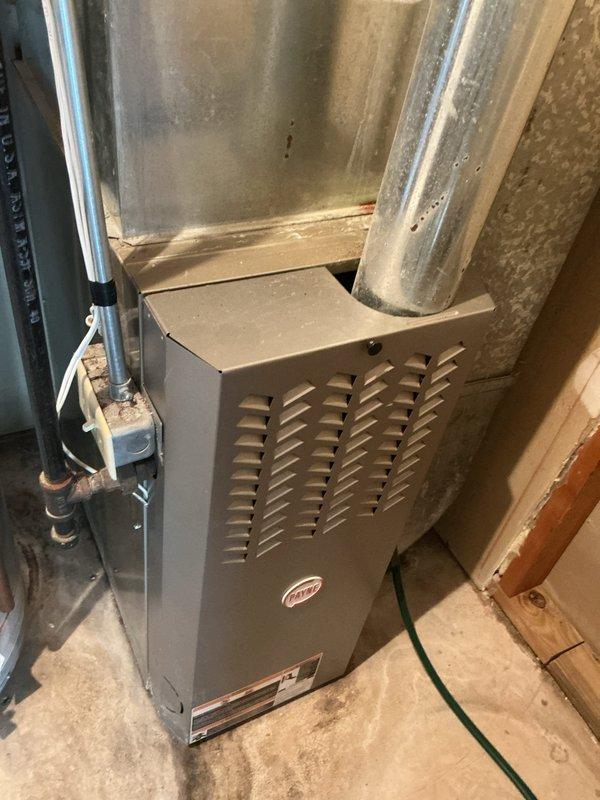 Responded to no cooling call with thermostat set at 72°F and indoor temperature reading 82°F. Upon inspection, found system critically low on obsolete R22 refrigerant. Evaporator coil showed evidence of previous freeze-up incidents with water damage present on furnace heat exchanger below. Heat exchanger exhibited severe rust and corrosion with areas compromised to the point of potential cracking, creating imminent carbon monoxide safety hazard. Documented conditions with photos showing extensive condensation on furnace components and overall system deterioration. Due to age of equipment, obsolete refrigerant type, multiple component failures, and unsafe heat exchanger condition, recommended complete system replacement rather than repair. Scheduled replacement estimate appointment for customer review of options.