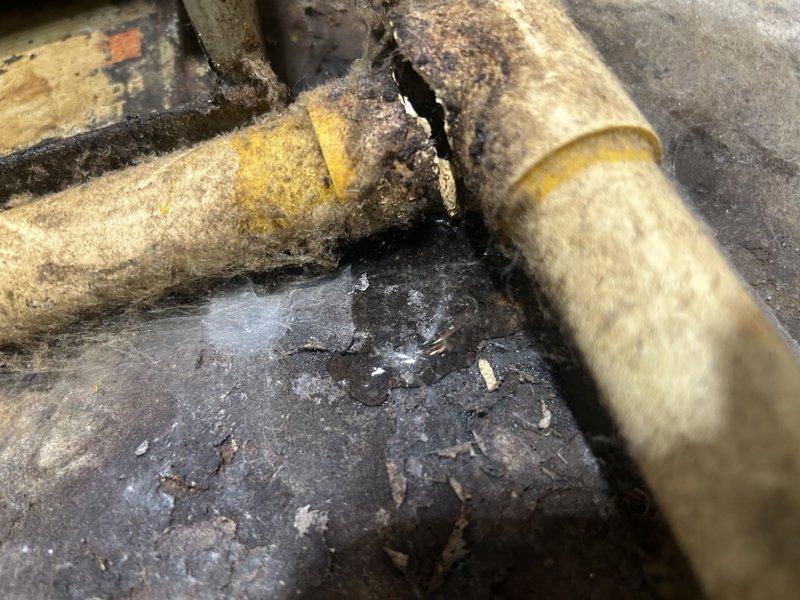 Responded to no cooling call on 25-year-old residential air conditioning system. Diagnosed indoor blower motor failing to maintain operation due to defective run capacitor testing at 8 out of 10 microfarads. Replaced failed capacitor, installed new air filter, and performed condenser coil cleaning to restore system functionality. System returned to normal operation with adequate airflow and cooling capacity. Noted system appears overcharged but has operated in this condition since installation without issue. Identified damaged section of condensate drain line requiring future repair and provided replacement pricing to customer.