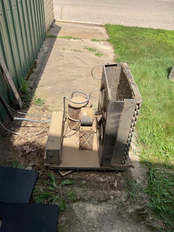 Responded to no cooling complaint at main office with two units down. The newer 23-year-old unit was off upon arrival; restarted unit and performed condenser coil cleaning due to heavy dirt accumulation. Unit operational after cleaning but noted possible low refrigerant charge and fan motor wobble requiring future attention. The second unit, approximately 60+ years old and severely deteriorated, was tested with new capacitor replacement but failed to maintain operation after brief runtime. Recommended complete replacement of older unit due to age and condition.