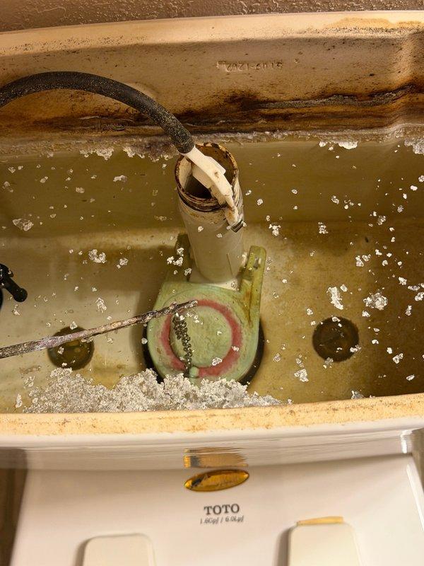 Responded to diagnose toilet flapper issue and inspect egress window drain system. Tested toilet flapper seal by performing multiple flush cycles and monitoring fill valve operation—flapper functioning properly with no leaks detected. Deployed portable inspection camera through egress window drain line to foundation, confirming drain pipe is clear and unobstructed. Identified drainage issue caused by drain cover blocked by rubber matting and rocks, restricting water flow. Discovered black tarp installed beneath rock layer in window well, preventing proper water percolation and drainage. Advised property owner to remove tarp and redistribute rock fill to restore proper drainage function.