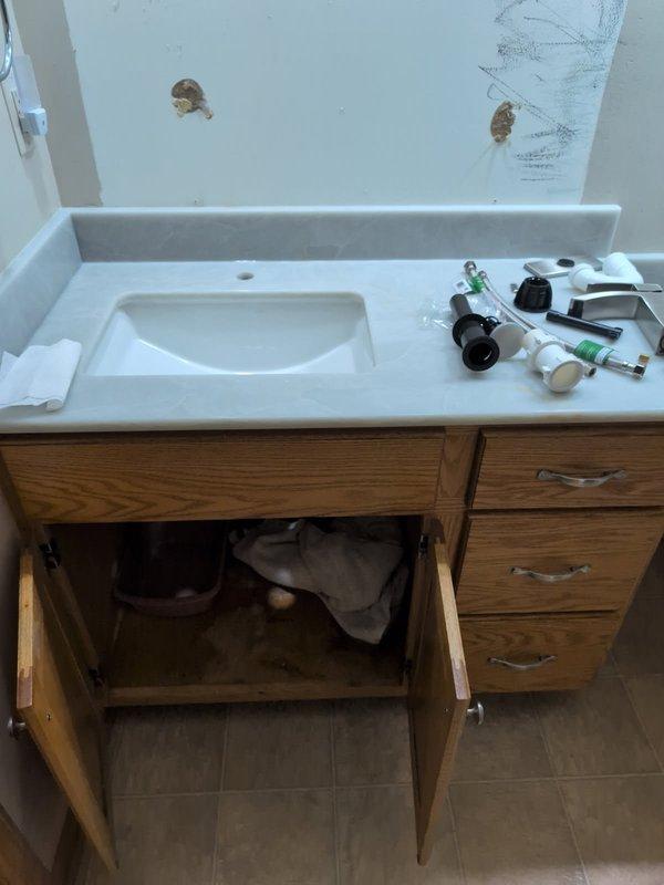 Completed installation of two customer-supplied lavatory faucets in bathroom vanity areas. Both faucets were successfully mounted to white countertops with integrated sink basins, with all water supply connections properly secured and tested for leaks. All fixtures are functioning correctly with proper hot and cold water flow confirmed upon completion.